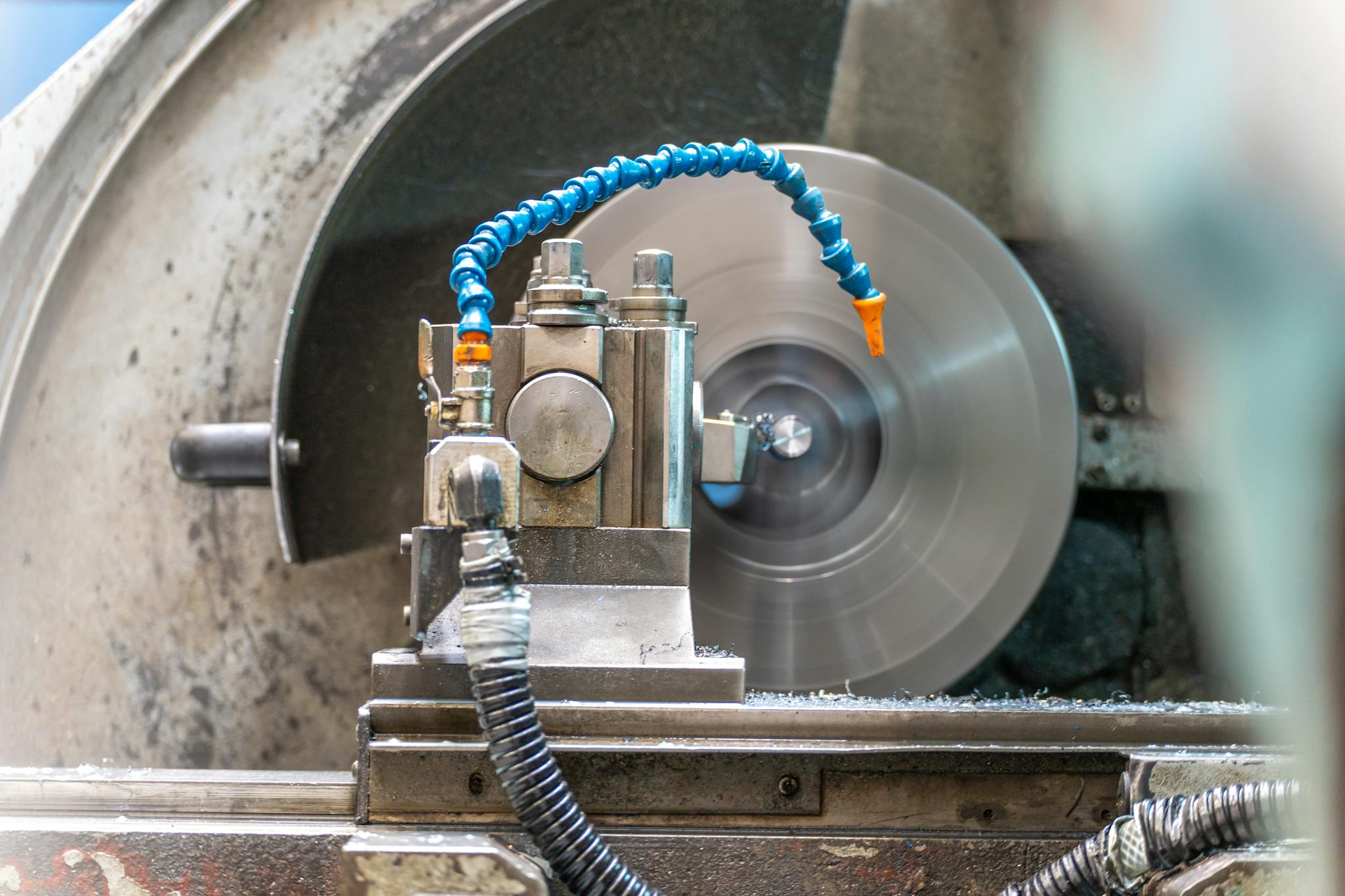 Close-up of a spinning lathe machine in an industrial workshop setting.